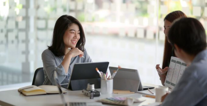 Cropped shot of team application developer consulting on UI project in meeting room